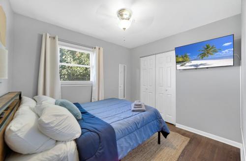 a bedroom with a blue bed and a window at Cozy Private Room in Hammond, IN - 2 in Hammond