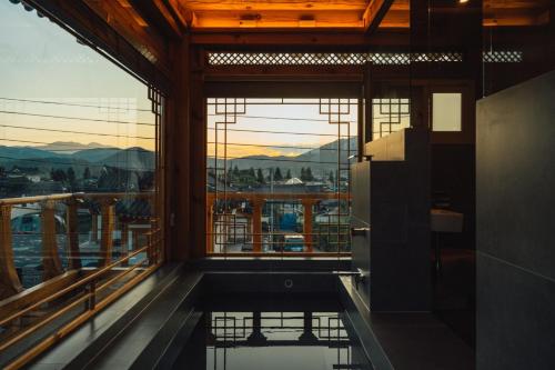 a room with a large window and a view of the city at Hanok Stay Seowa in Gyeongju