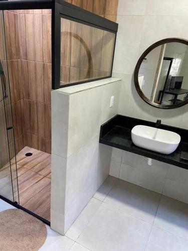 a bathroom with a sink and a mirror at Loft Iron em capim macio in Natal