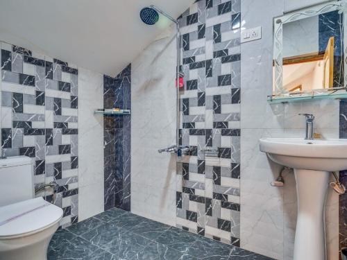 a bathroom with a sink and a toilet and a shower at Hotel River View Resort in Pahalgām