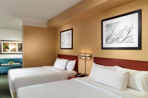 a hotel room with two beds and a desk at SpringHill Suites by Marriott Atlanta Buckhead in Atlanta