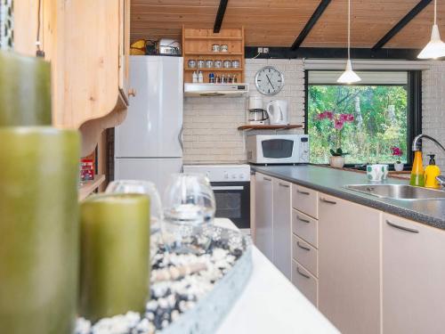 a kitchen with a counter with a sink and a refrigerator at Charming Retreat by River - By Traum Ferienwohnungen in Fårvang