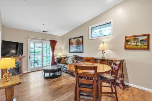 a living room with a table and a couch at Grand Wood Suites - 3rd Floor Front Side Corner Penthouse Suite 304 in Nashville