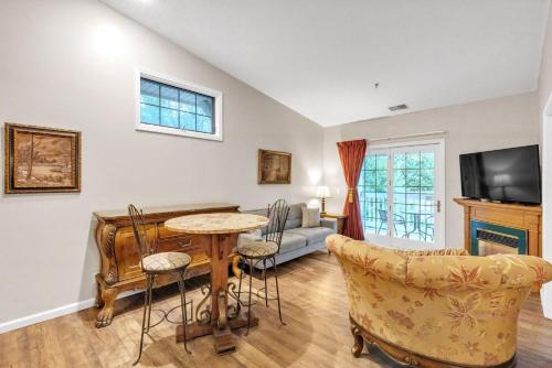 a living room with a table and chairs and a couch at Grand Wood Suites - 3rd Floor Back Side Corner Penthouse Suite 308 in Nashville