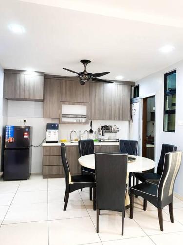 a kitchen with a table and chairs and a refrigerator at 3R2B in Skudai, 10min to Sutera,Paradigm,UTM l 6-9pax in Lima Kedai