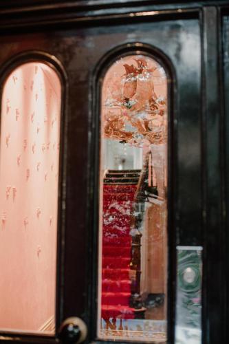 a reflection of a staircase in a glass window at Medusa Hotel Sydney in Sydney