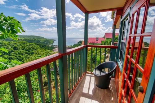 a balcony with a view of the ocean at Tropical Paradise View in Anse La Raye