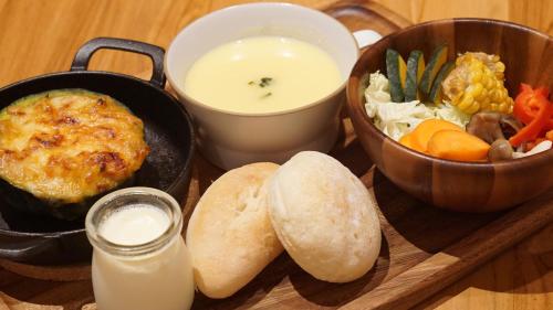 a tray with a plate of food and a bowl of food at Farm Stay Ezura Farm in Engaru