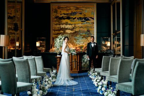 a bride and groom walking down the aisle at their wedding at The St. Regis Osaka in Osaka