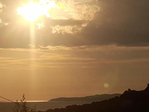 a sunset over the water with the sun in the sky at angelos aparts11 in Arillas