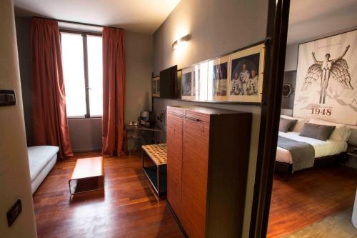 a room with a bedroom with a bed and a dresser at Art Hotel Boston in Turin