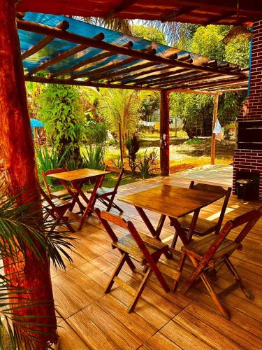 a wooden table and chairs on a wooden deck at Vila Itacimirim in Itacimirim