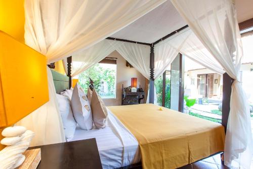 a bedroom with a bed with a canopy at Villa Chantal-Intimate Villa in Seminyak in Seminyak