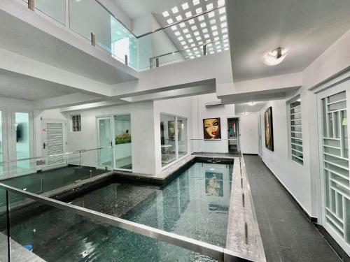 an indoor swimming pool in a house with glass floors at Casa de Verde Suites at Ocean Park in San Juan