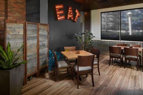 a dining room with a wooden table and chairs at Four Points by Sheraton Virginia Beach Oceanfront in Virginia Beach