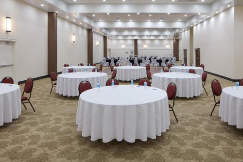 a banquet hall with white tables and chairs at Four Points by Sheraton Virginia Beach Oceanfront in Virginia Beach