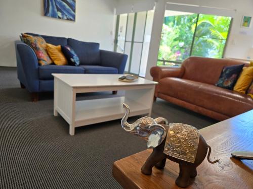 a living room with an elephant statue on a table at Noosa River Retreat Holiday Apartments in Noosaville