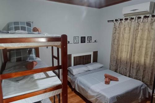 a bedroom with two bunk beds and a window at Blaues Haus 2 in Pomerode