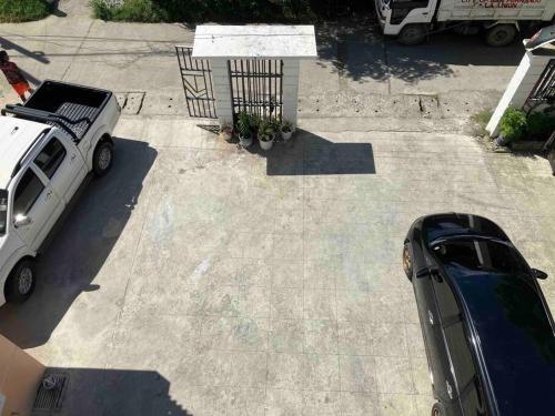 a parking lot with a car parked in a driveway at 1BR Tropical Penthouse for 4 guests, near beach in Bangcusay
