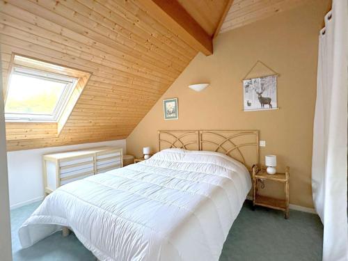 une chambre avec un grand lit blanc avec une fenêtre dans l'établissement T2 Duplex 6 Pers - Terrasse, Parking, Salle Musculation - Saint Lary Soulan - FR-1-457-348, à Saint-Lary-Soulan