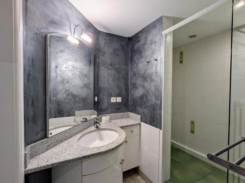 une salle de bain avec un lavabo et un miroir dans l'établissement Gîte cosy au cœur de Gérardmer avec jardin et terrasse - FR-1-589-670, à Gérardmer