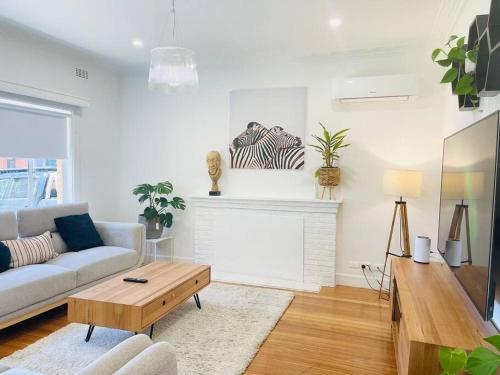 a living room with a couch and a fireplace at D133 St Alban station stay in St Albans
