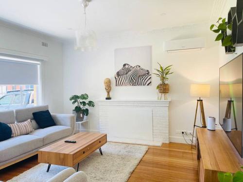 a living room with a couch and a fireplace at D133 St Alban station stay in St Albans