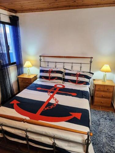 a bedroom with a bed with an anchor on it at Ocean's Edge in Horta