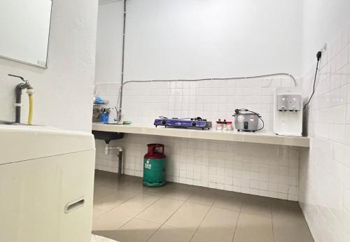 a white kitchen with a counter with appliances on it at CikSiti homestay02 in Kajang