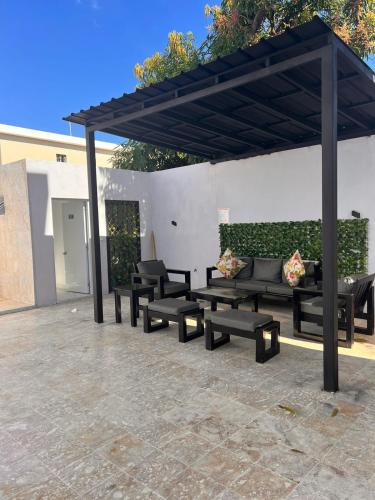 a group of benches sitting under a pavilion at Crown ll-3 Bedrooms-Pool-Close to everything! in San Felipe de Puerto Plata