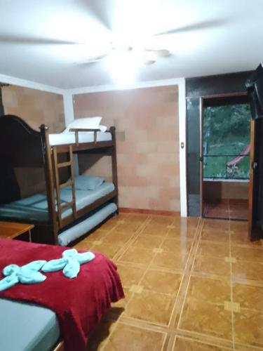 a room with a bed and a couch and a window at Finca Hotel Villa Mia in Girardota