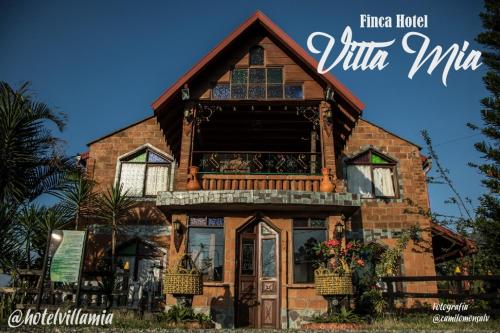 a house with a large window on the front of it at Finca Hotel Villa Mia in Girardota