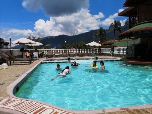 a group of people in a swimming pool at Finca Hotel Villa Mia in Girardota