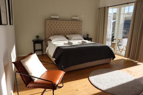 a bedroom with a large bed and a balcony at Serenity in Eşelniţa