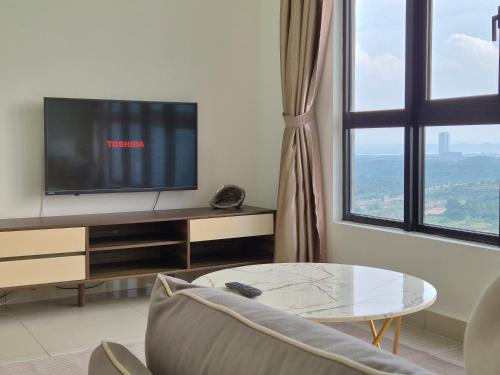 a living room with a tv and a coffee table at Medini Family suites for 3 pax - Next to Legoland in Nusajaya