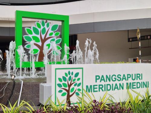 a sign in front of a fountain at Medini Family suites for 3 pax - Next to Legoland in Nusajaya