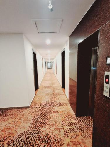 an empty hallway with a tile floor in a building at The Fern Residency, Bodhgaya in Bodh Gaya