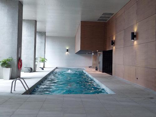 a swimming pool in a building with blue water at Melbourne Single family apartment 2Br 2Bth Indoor Pool Sauna in Melbourne