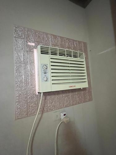 a air conditioner on a wall in a room at CAVR Building in Tarlac
