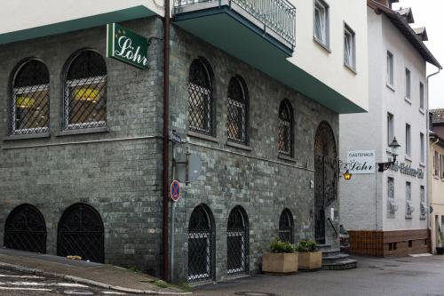 a brick building with arched windows on a street at Hotel Löhr in Baden-Baden