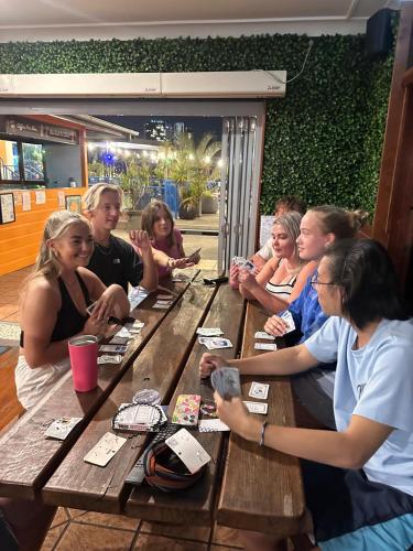 a group of people sitting at a picnic table at City Backpackers HQ in Brisbane