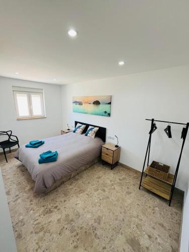 a bedroom with a bed and a painting on the wall at Renbeck lets 1 in Urcal