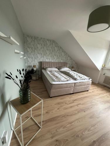 a bedroom with a bed and a table in it at Ferienhaus Pirmasens in Pirmasens