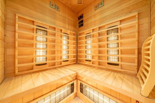 a sauna with wood paneling and windows at Aparthotel Sunrise in Ramsau am Dachstein