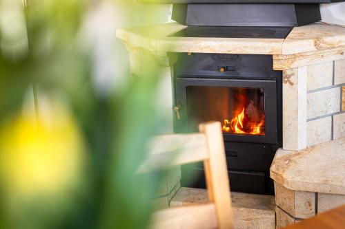 a brick oven with a fire in it at Holiday Home Smržovka in Smržovka