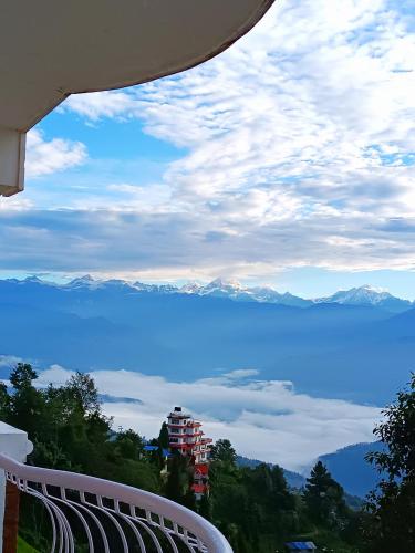 a view of the lake and mountains from a balcony at Mountain Vista Retreat in Nagarkot