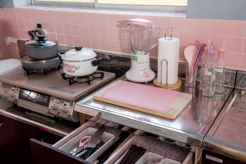 a kitchen counter with a stove with a blender at Benton Guesthouse, Private Nostalgic Showa-era House, former "Akiya" in Imabari