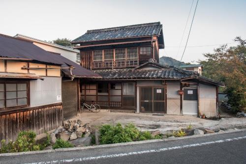 an old house on the side of a street at Benton Guesthouse, Private Nostalgic Showa-era House, former "Akiya" in Imabari
