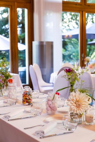 a white table with glasses and flowers on it at Le Saint Georges in Gruyères