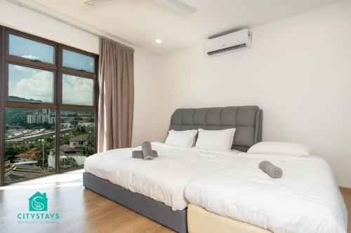 a bedroom with a large bed and a large window at D'Moon Escapes Ampang KL 4BR in Kampong Ulu Kelang